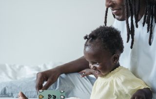 toddler and dad reading book