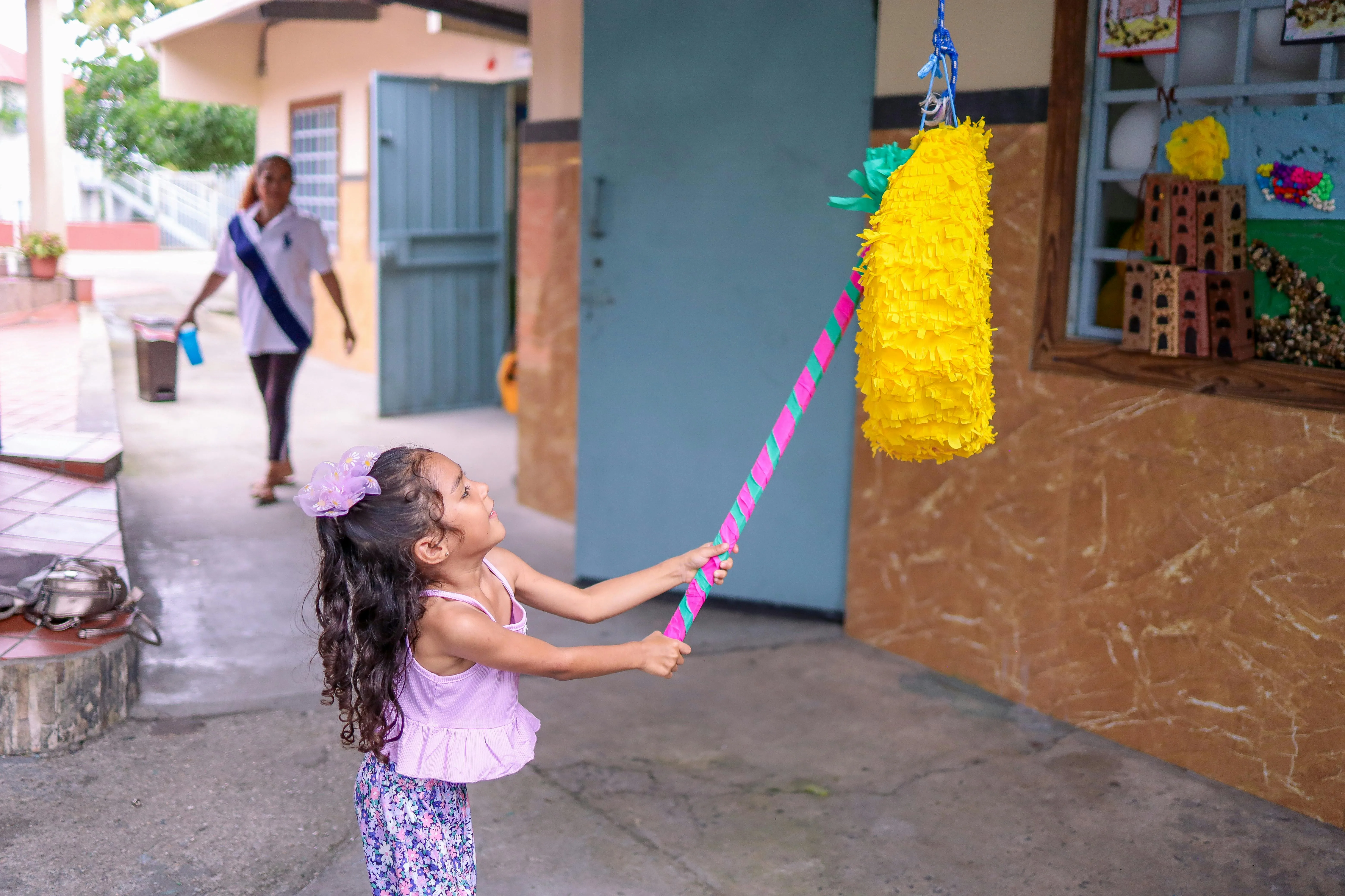 Child hitting a mini pinata