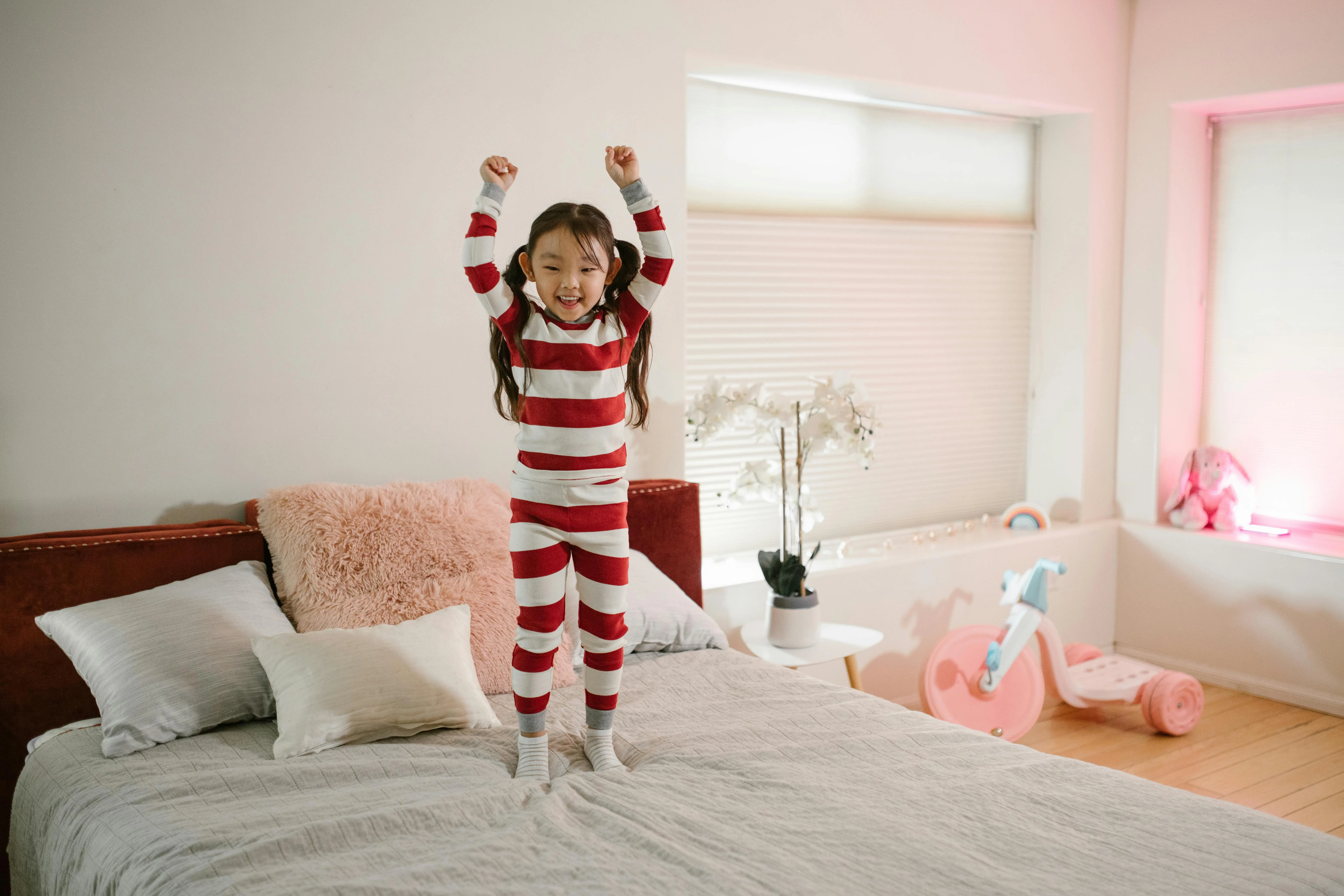 Toddler jumping on the bed