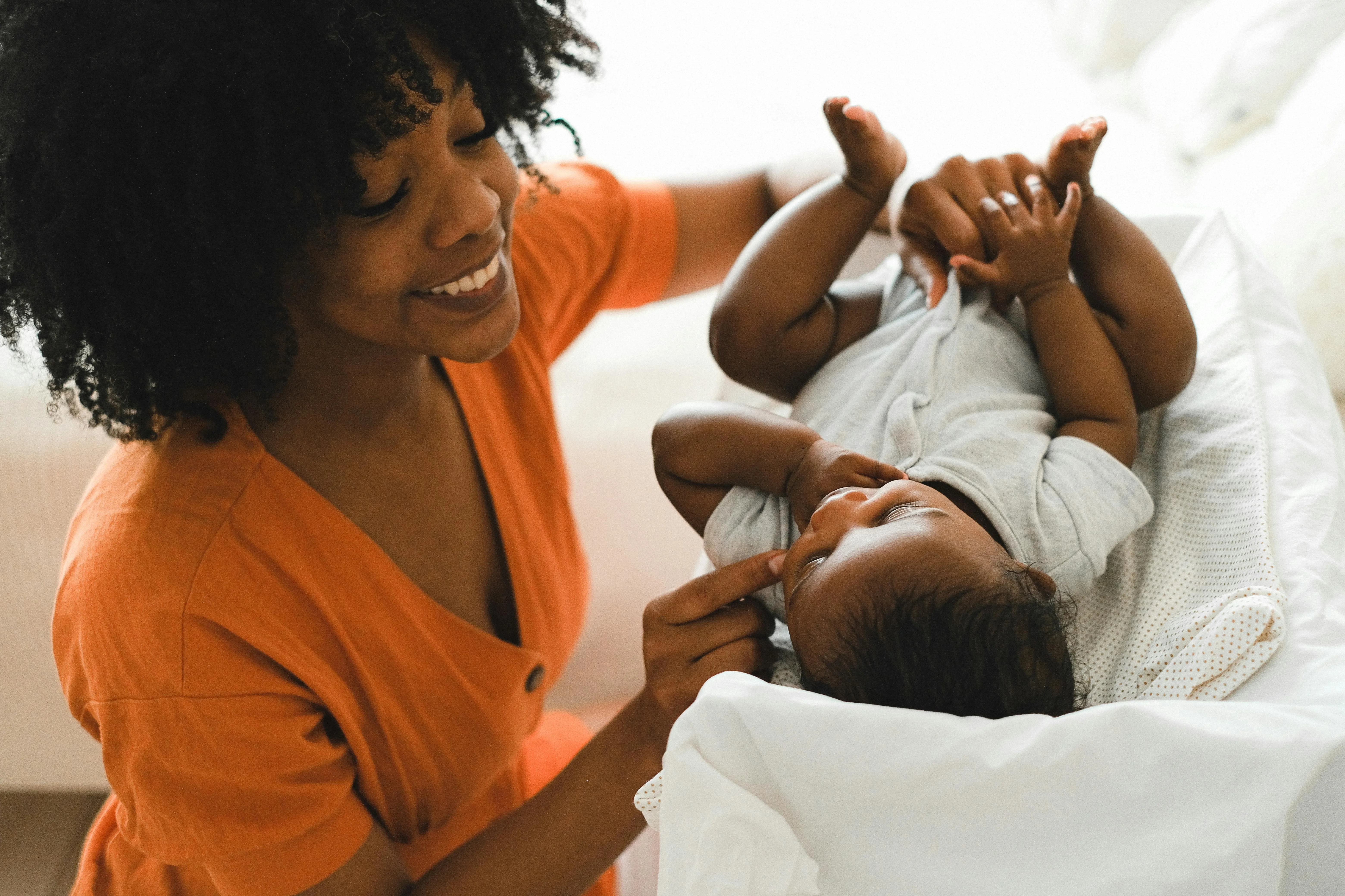 Au Pair changing baby's diaper