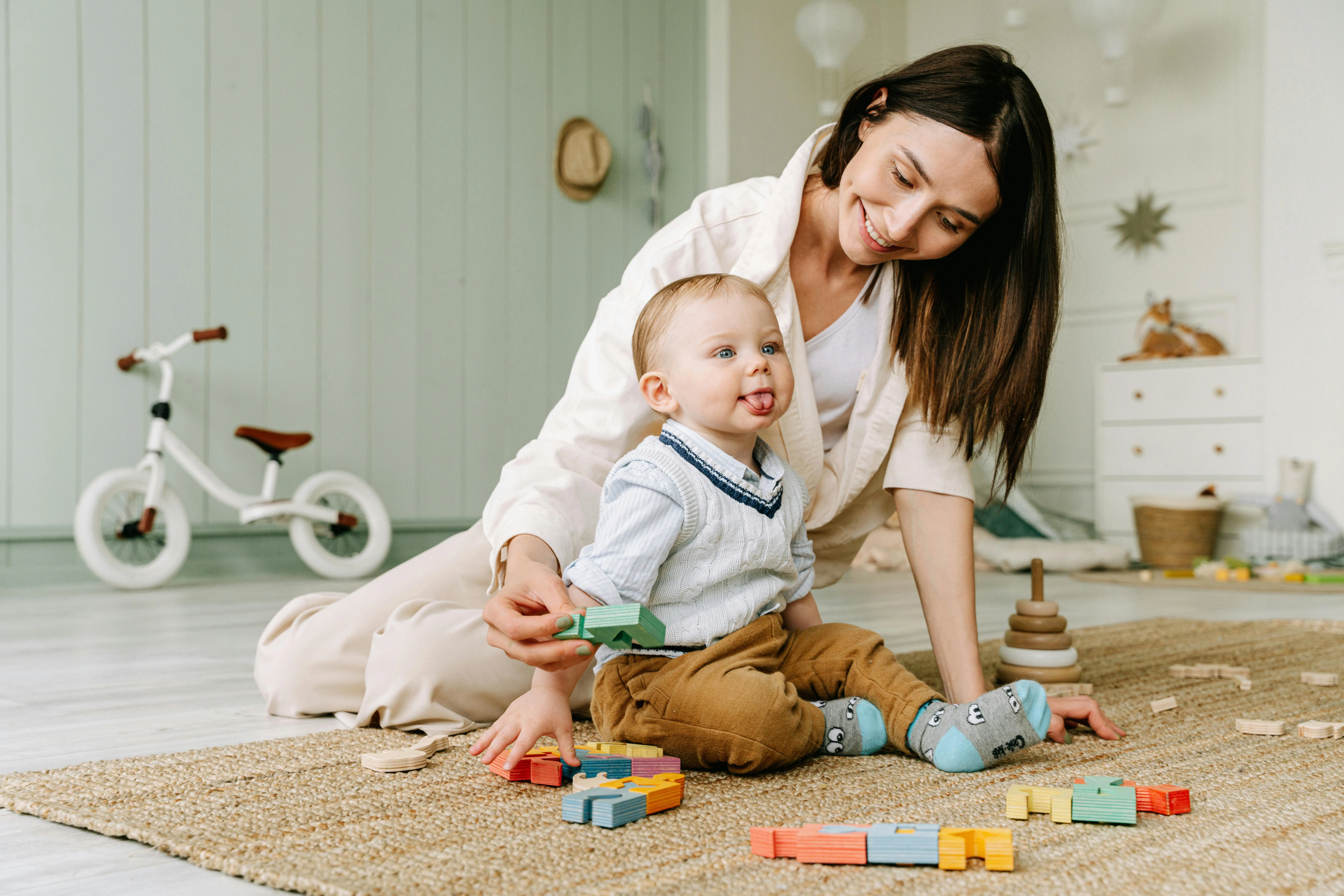 Au Pair and baby playing on the floor