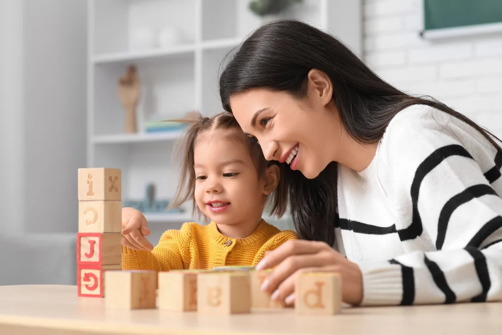 An Au Pair overcomes language barriers to play with her young charge.