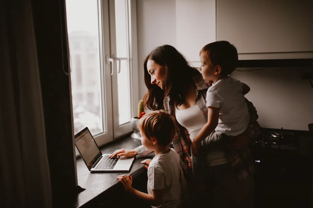 An Au Pair uses a shared family calendar with her two young charges.