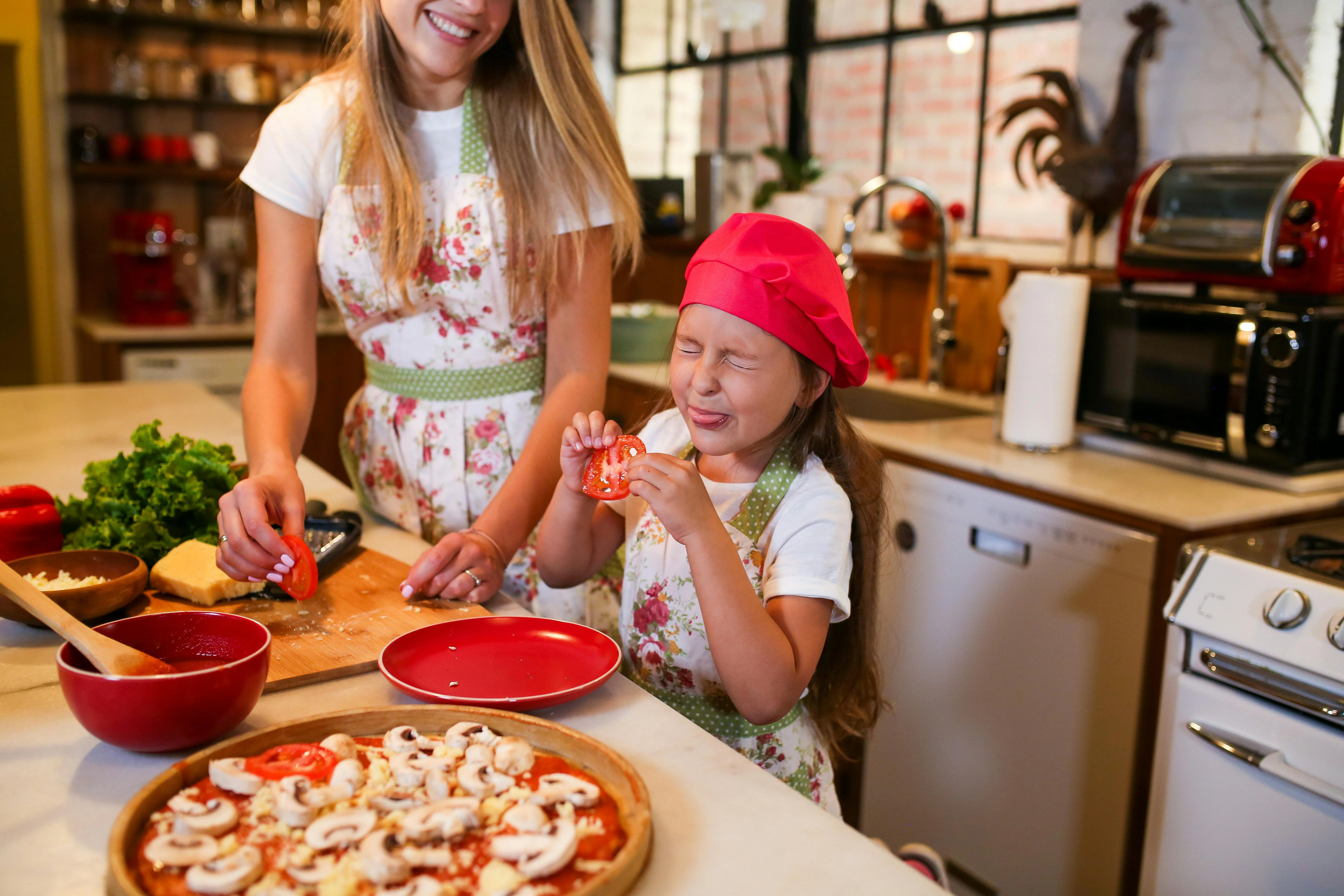 Au Pair and child cooking together