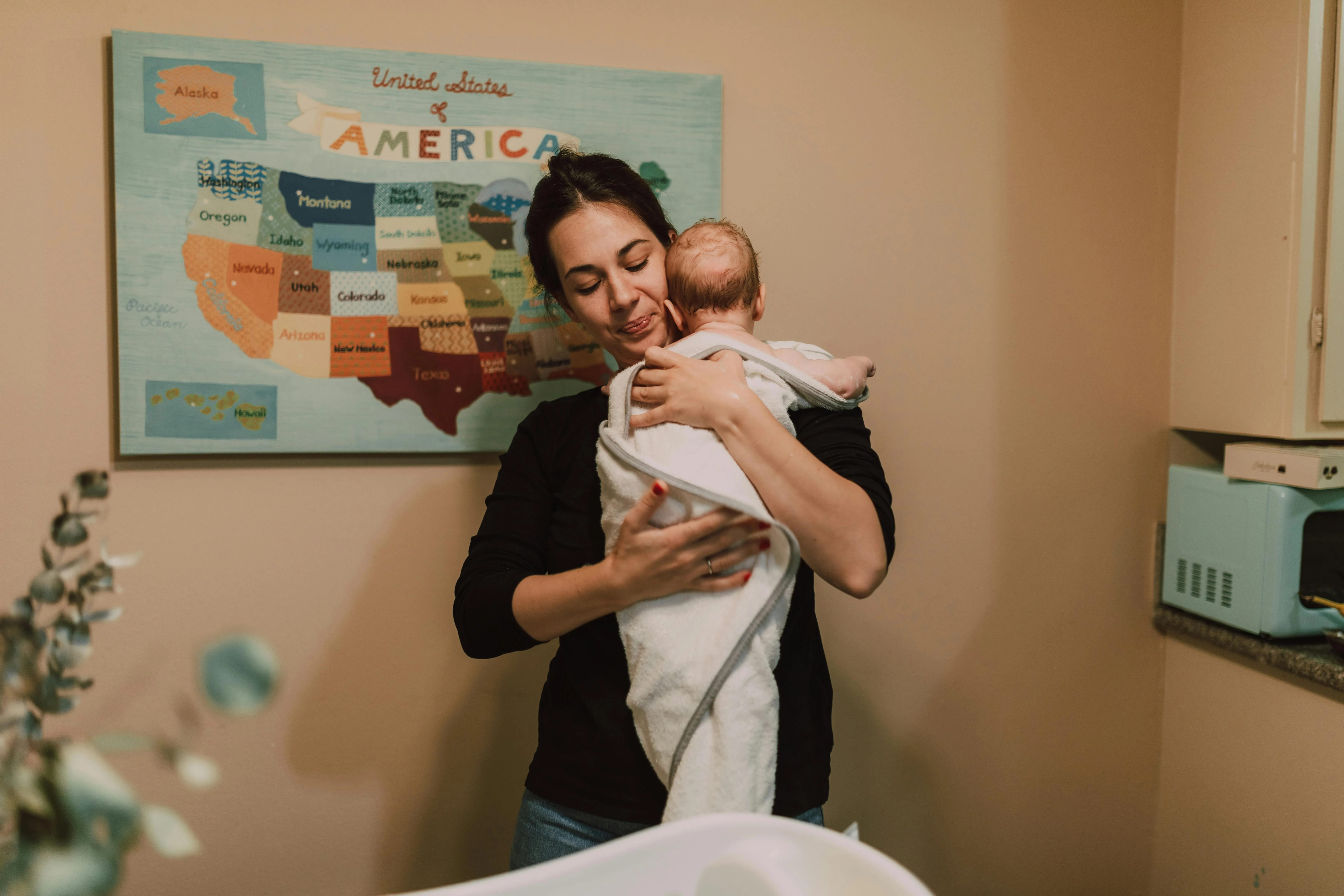 Au Pair swaddling a baby