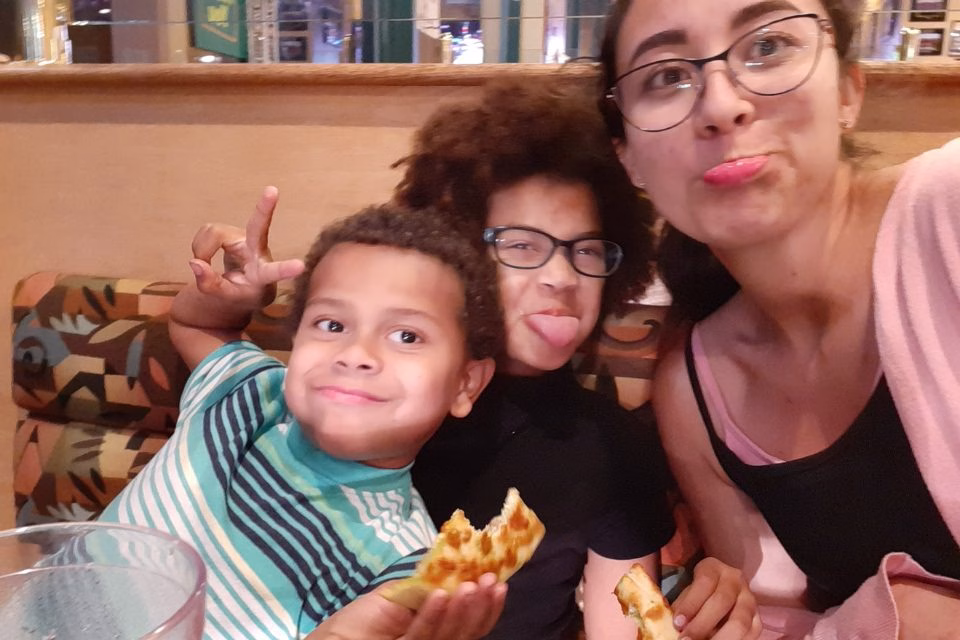 Au Pair enjoying pizza with her Host Kids