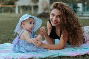 Au Pair and baby playing outside