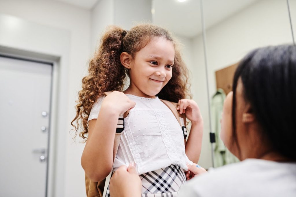Au Pair helping child get ready for school