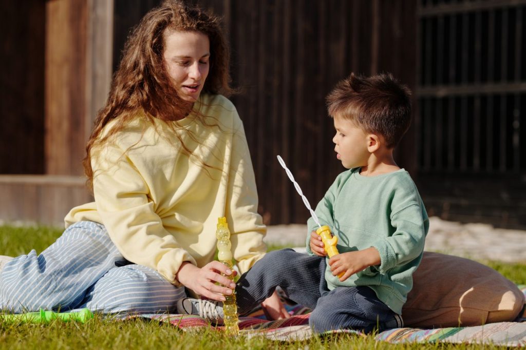 Au Pair playing with child outside